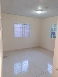 Contemporary kitchen with granite counters and bright windowed design in Guadalupe La Chorrera