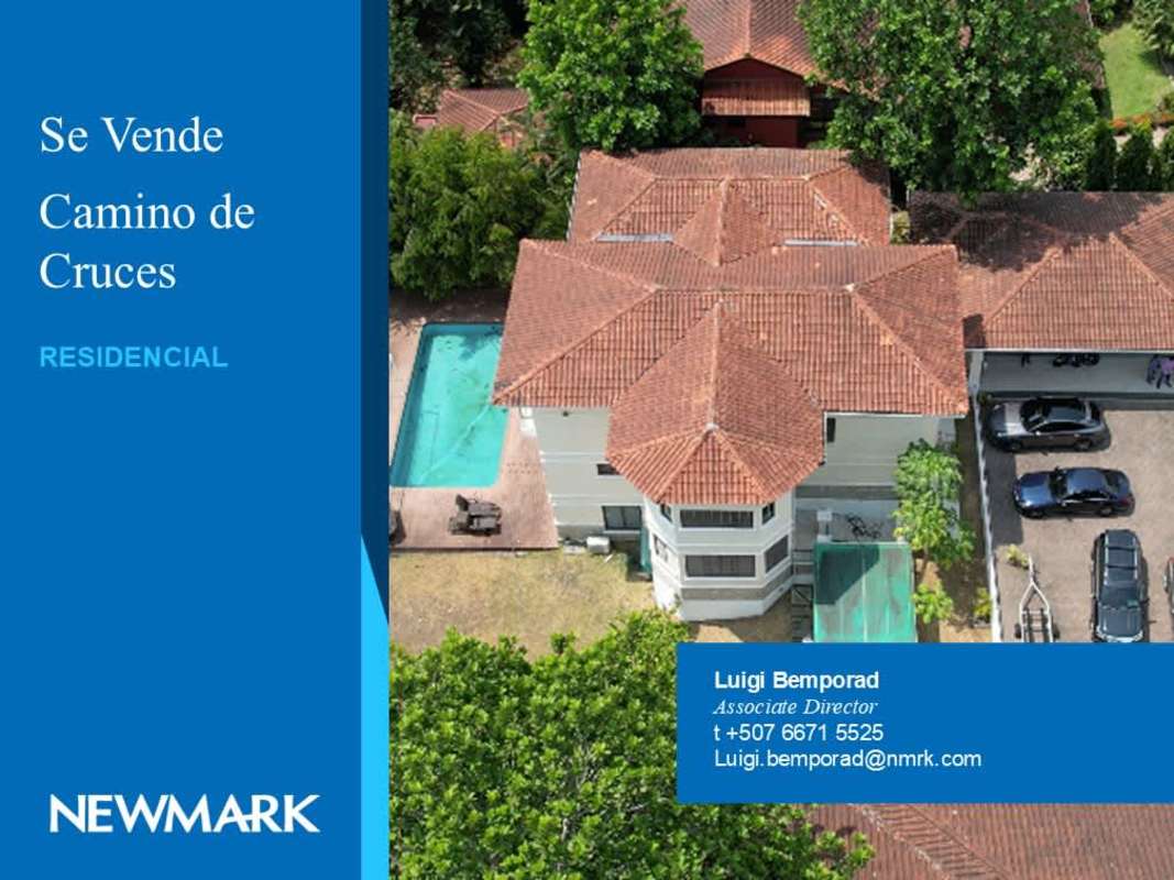 Aerial photo of luxury residence with red tile roof, private pool, driveway and lush trees in Camino de Cruces