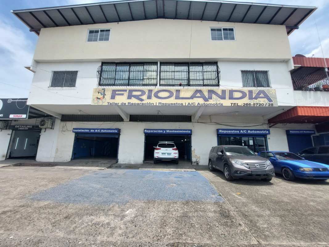 Exterior of mixed-use commercial building with signage and parking in Juan Díaz Panama City