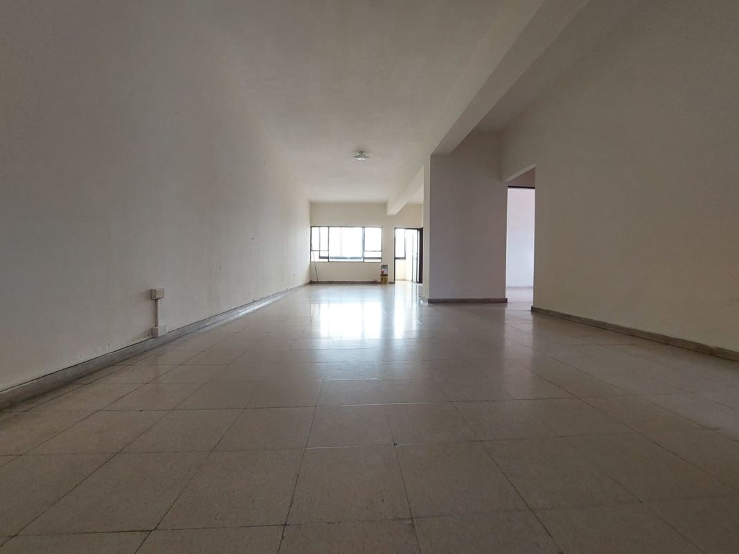 Spacious living room with tiled floor and large windows in Juan Díaz apartment Panama City
