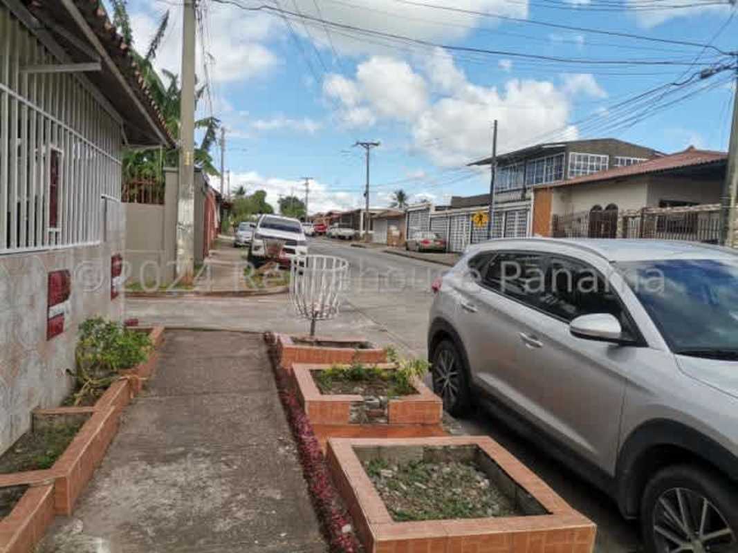 Living room with upholstered sofa, dining set, burgundy carpet, Don Bosco house Panama