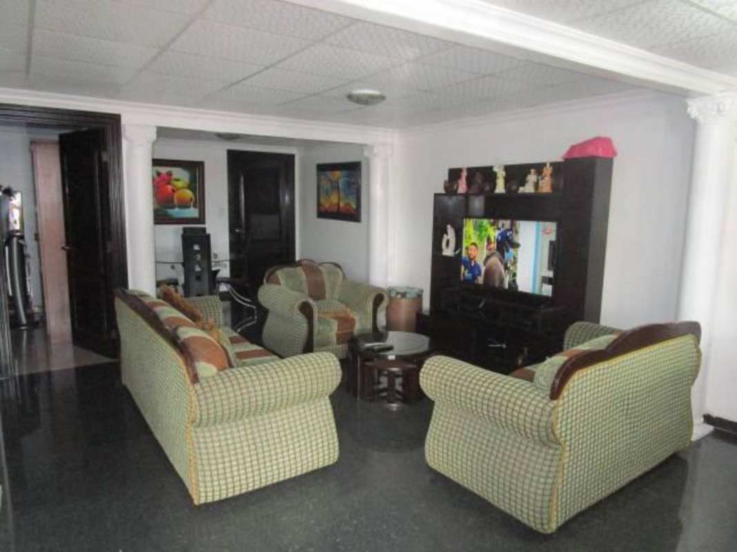 Spacious living room with entertainment center and tiled floors in Tocumen house