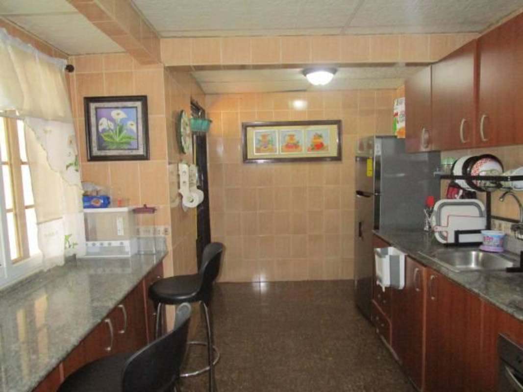 Granite countertop kitchen with wood cabinetry in Brisas del Golf Tocumen Panama