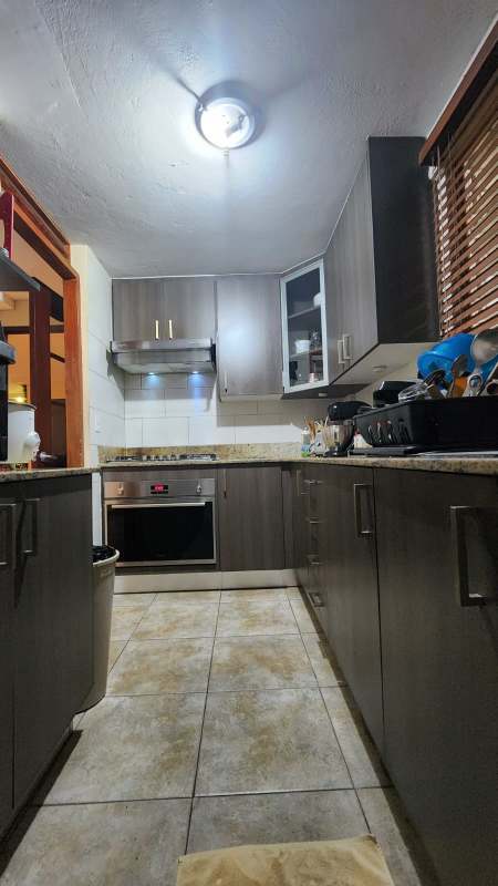Closed kitchen with cabinetry, ceramic tile flooring in Condo El Jilguero Panama
