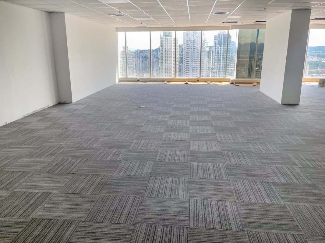 Panoramic window open office area overlooking Panama City skyline in Evolution Tower