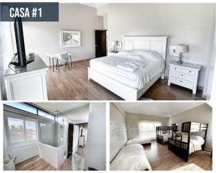 Spacious bedroom with large windows and balcony access at Punta Barco beach house Panama