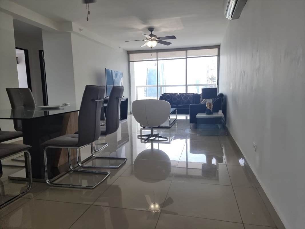 Open plan living room with modern decor, tile floors, AC and large windows PH Obarrio Tower Panama City