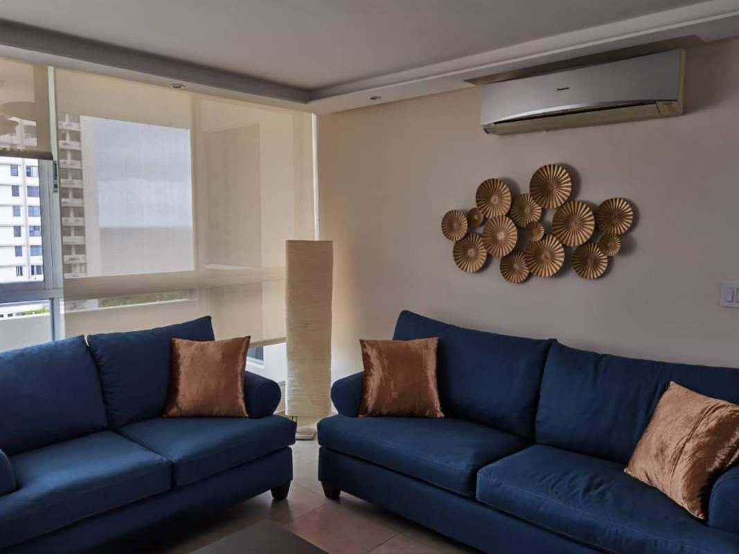 Furnished bedroom with large window, ocean and skyline views at PH South Beach Avenida Balboa