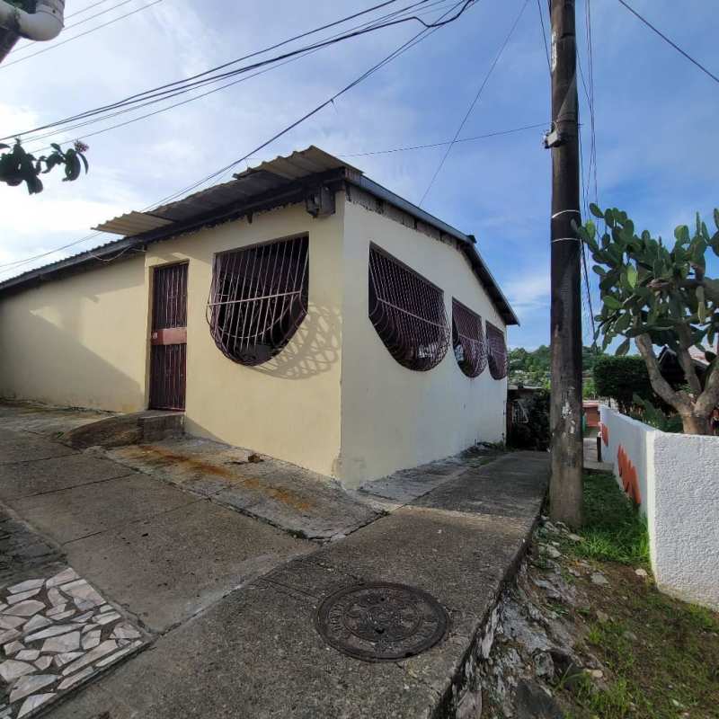 Traditional tiled-floor living room with windows and sofas Villa Guadalupe San Miguelito Panama