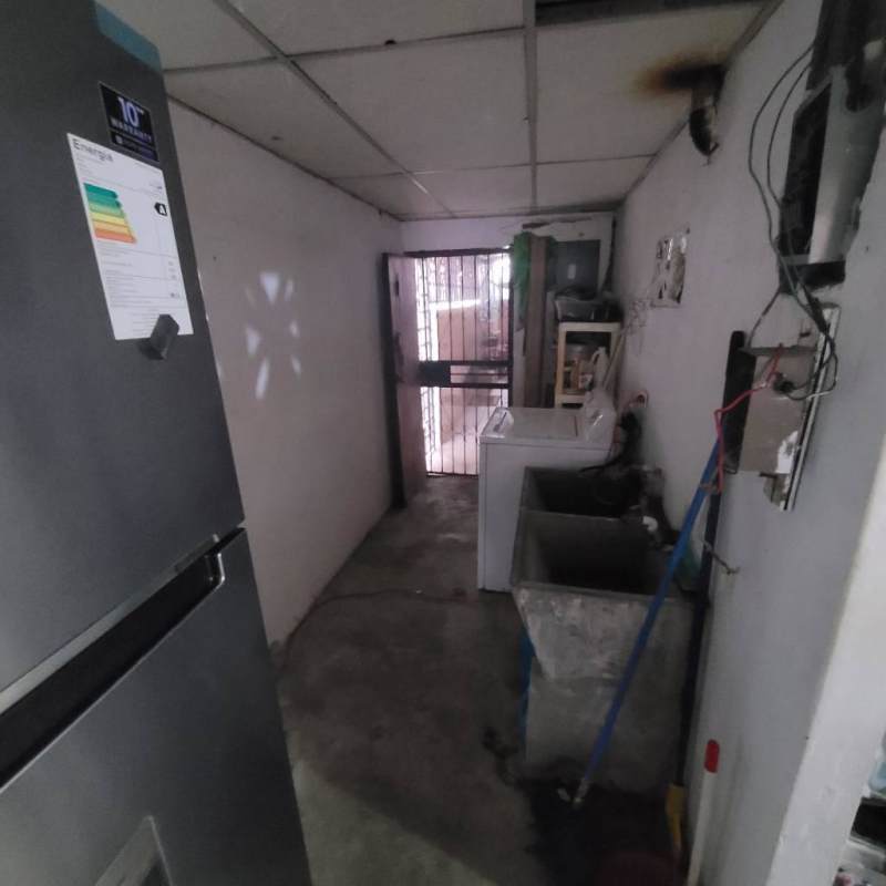 Laundry space with refrigerator, washer, utility sink in Villa Guadalupe Panama City