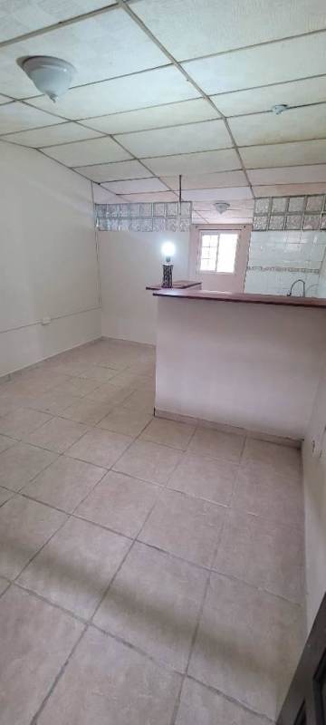 Basic kitchen with bar counter, glass block divider in Villa Guadalupe Panama
