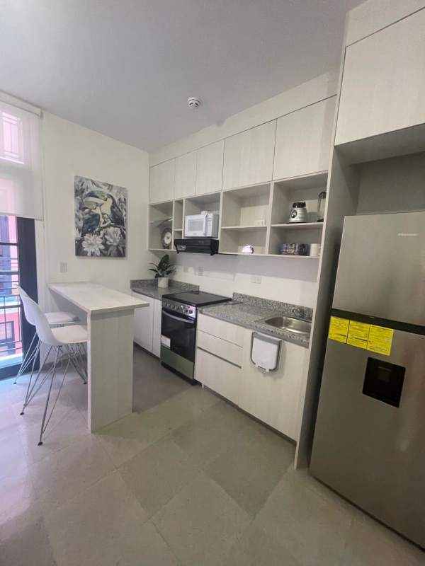 Contemporary kitchen with granite countertops and breakfast bar Casa Korsi Santa Ana Panama