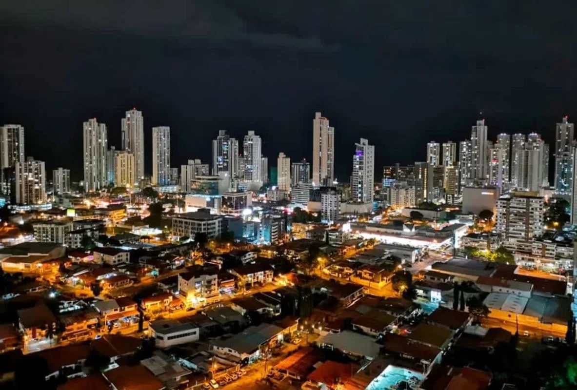 Illuminated Panama City skyline view from PH Sky Blue at night