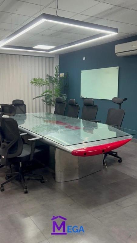 Glass conference room with ergonomic chairs and LED lighting in Los Angeles Villa Cáceres Panama