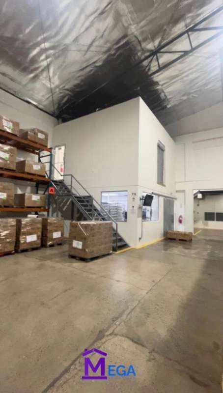 Warehouse interior view with mezzanine, stacked pallets, concrete floor in Los Angeles Panama City