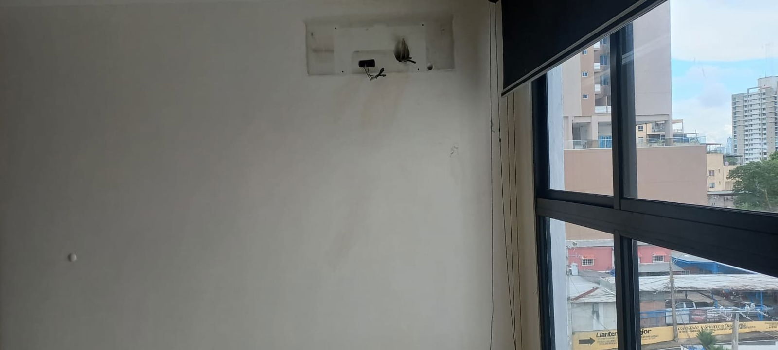 Interior room unfurnished large window city skyline view PH Vista Verde