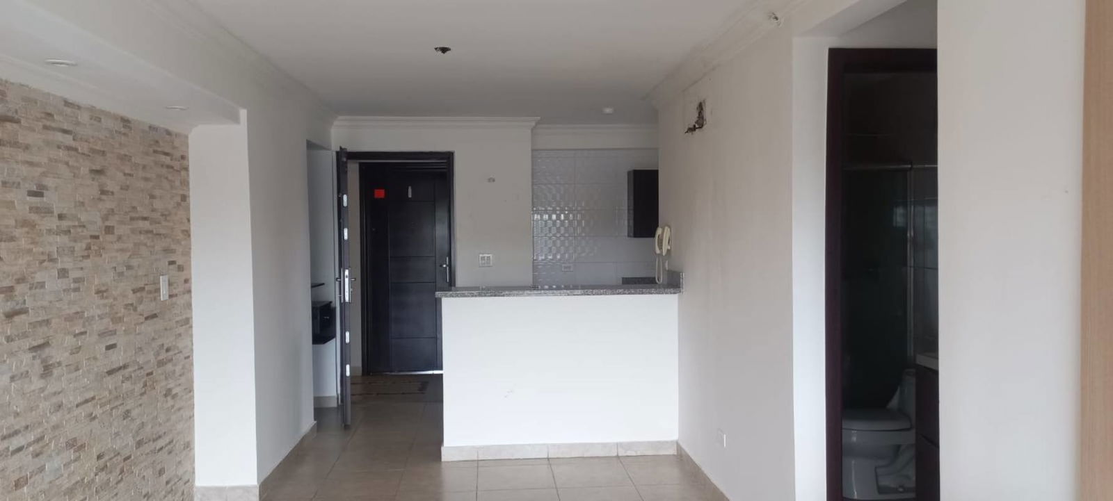 Apartment entry open kitchen granite counters tiled wall PH Vista Verde