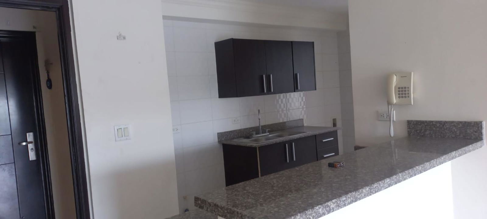 Modern kitchen with black cabinetry granite counters PH Vista Verde Panama