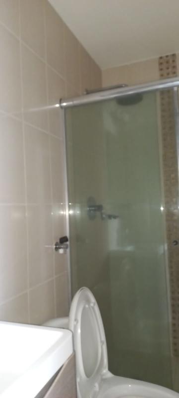 Bathroom with beige tiled walls and glass shower PH Vista Verde Panama
