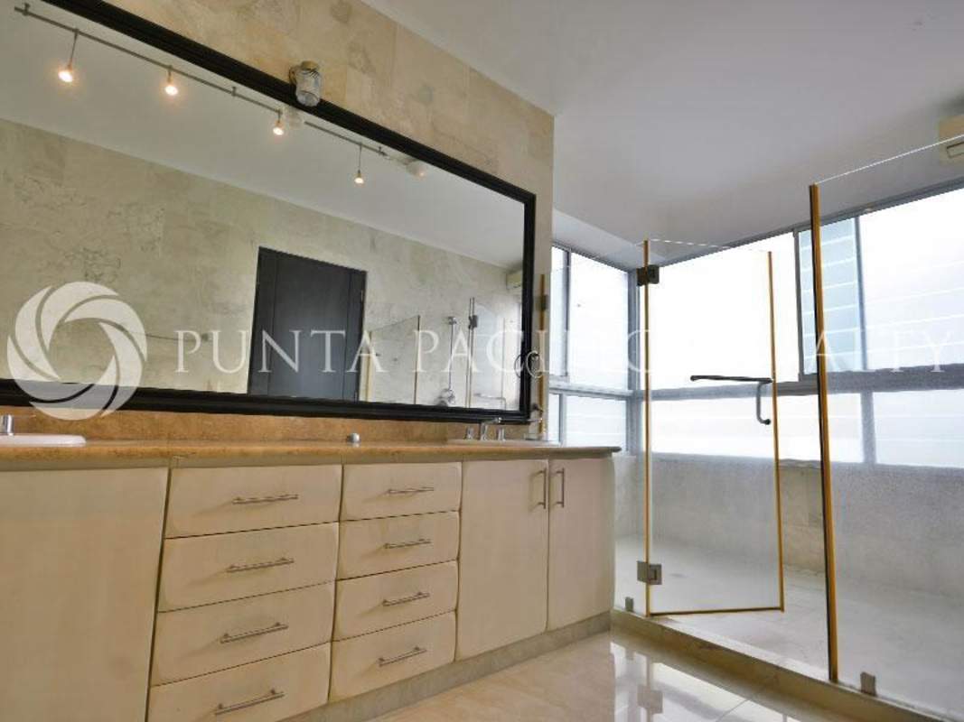 Spacious kitchen with wood cabinetry, granite countertops at PH Aquamare Panama