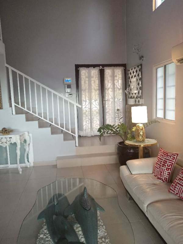 Luxury living room with double-height ceiling and chandelier in house Condado del Rey Panama