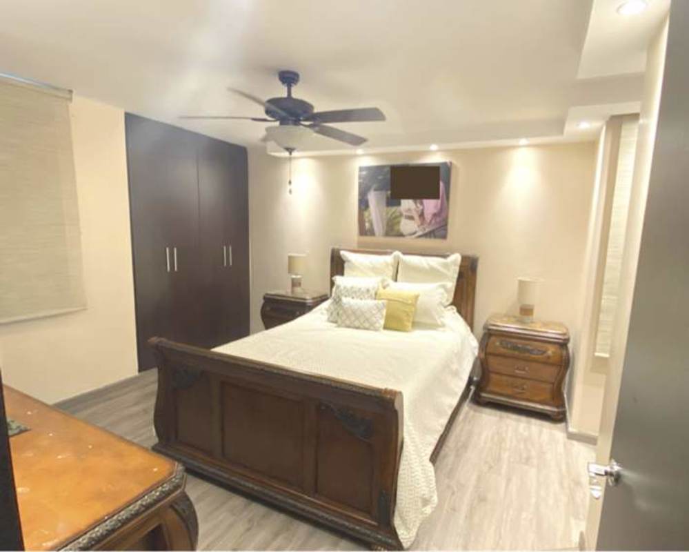 Spacious master bedroom with ceiling fan, built-in wardrobe, wood floors in Sunrise Tower Panama City