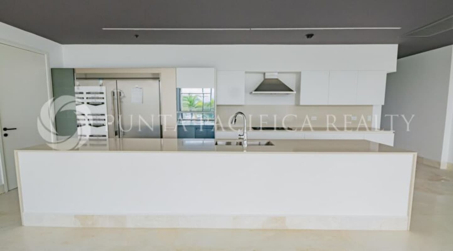 Bright modern living room with large glass windows, ocean view in Beach Club Residences