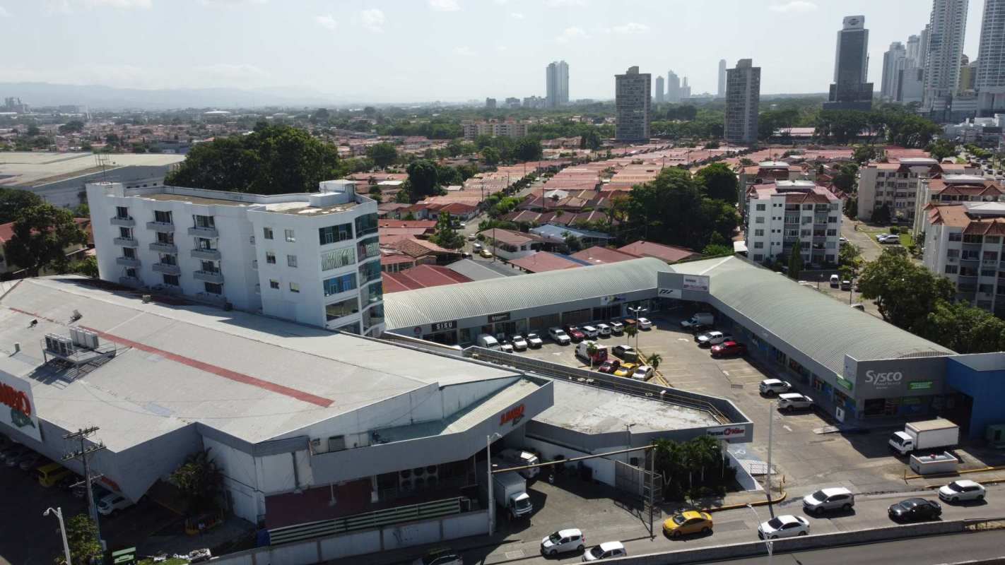 Aerial view commercial complex with parking and nearby residential towers Costa del Este
