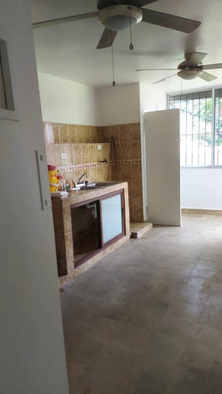 Simple kitchenette area with ceiling fans, large window in commercial space Calle 50 Panama