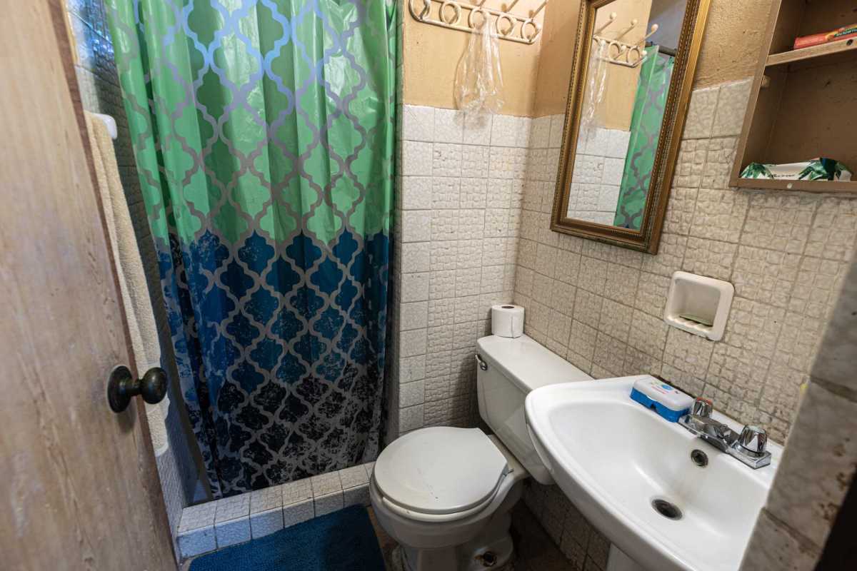 Contemporary bathroom with dual sinks and marble counter in El Carmen house Panama City