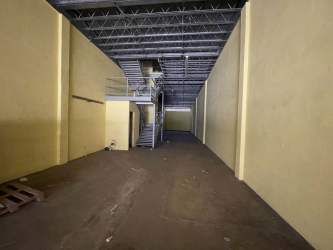 Interior storage space with exposed ceiling beams in Colon Free Zone warehouse for rent