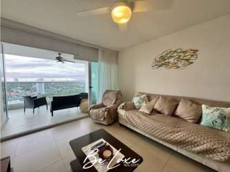 Bright living room with glass doors to balcony and ocean view at PH Bahia Nueva Gorgona