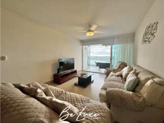 Master bedroom with large windows and ocean view in PH Bahia at Playa Serena Panama