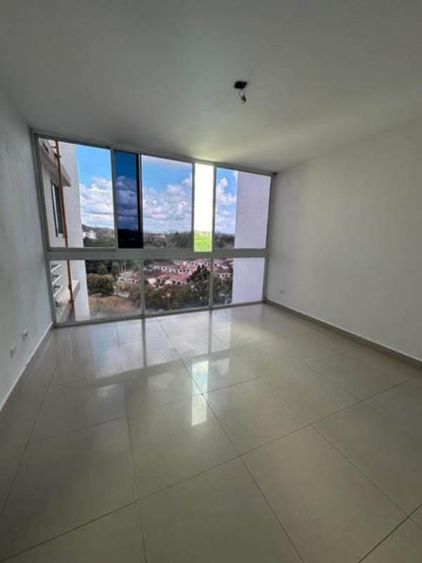 Living room with large windows allowing city skyline views at PH Pine Hill, Panama City