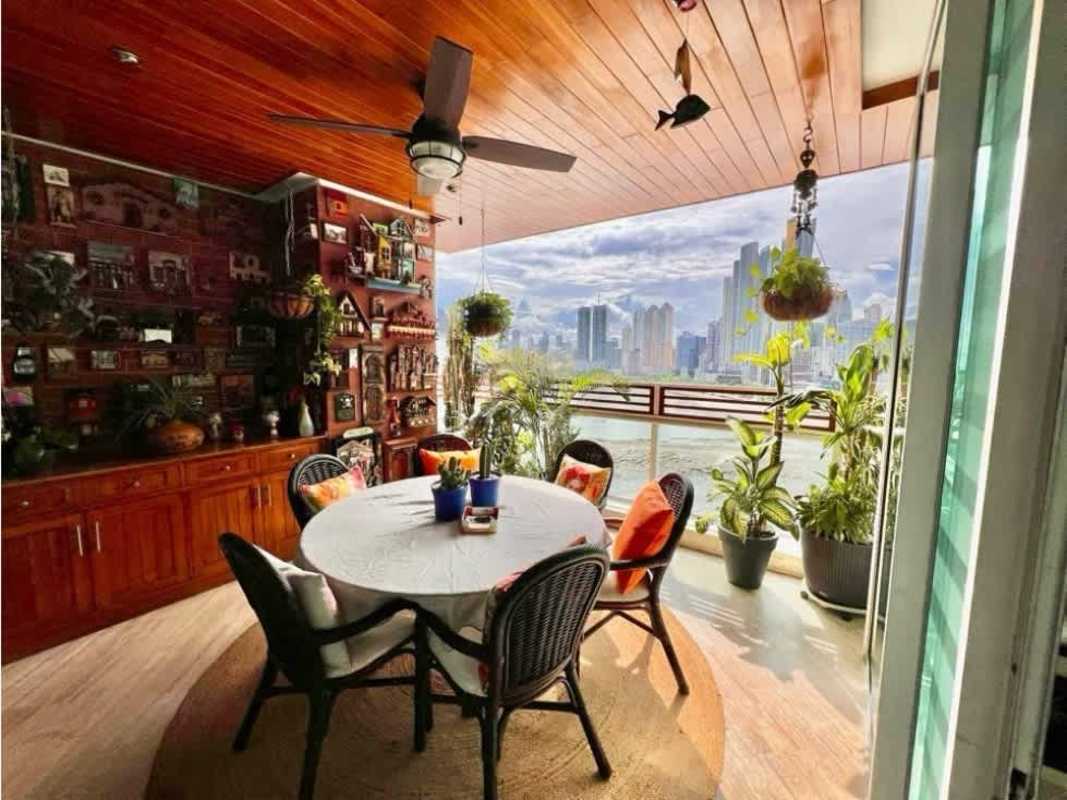 Elegant dining area with wood ceiling, artistic decor and marble flooring in PH Bayside Punta Paitilla Panama