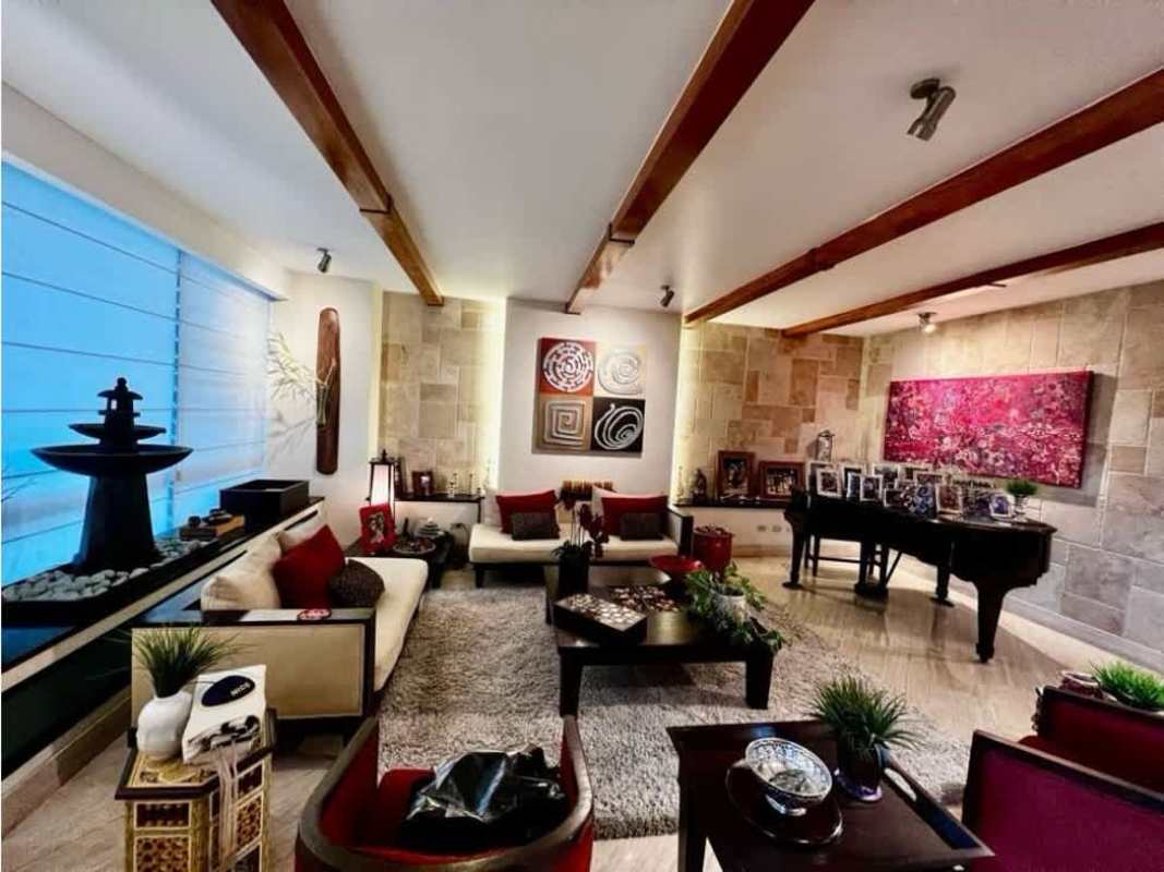 Modern living room with art, stone accent wall, piano and contemporary furniture in PH Bayside Punta Paitilla Panama