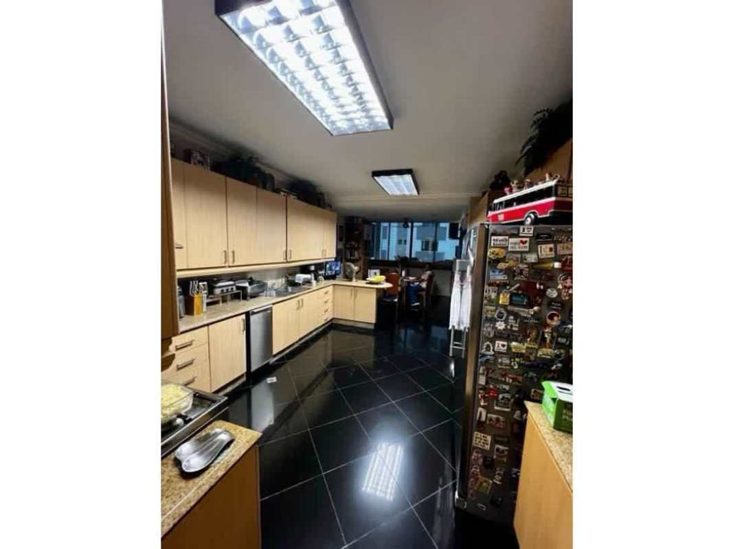 Contemporary kitchen featuring wood cabinets, tile flooring, and granite counters in PH Bayside Punta Paitilla Panama