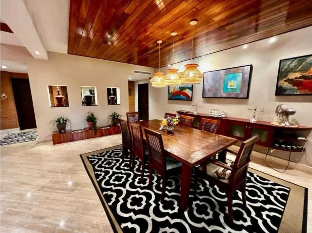 Kitchen with wood cabinetry, granite countertops and black tile flooring PH Bayside Punta Paitilla Panama