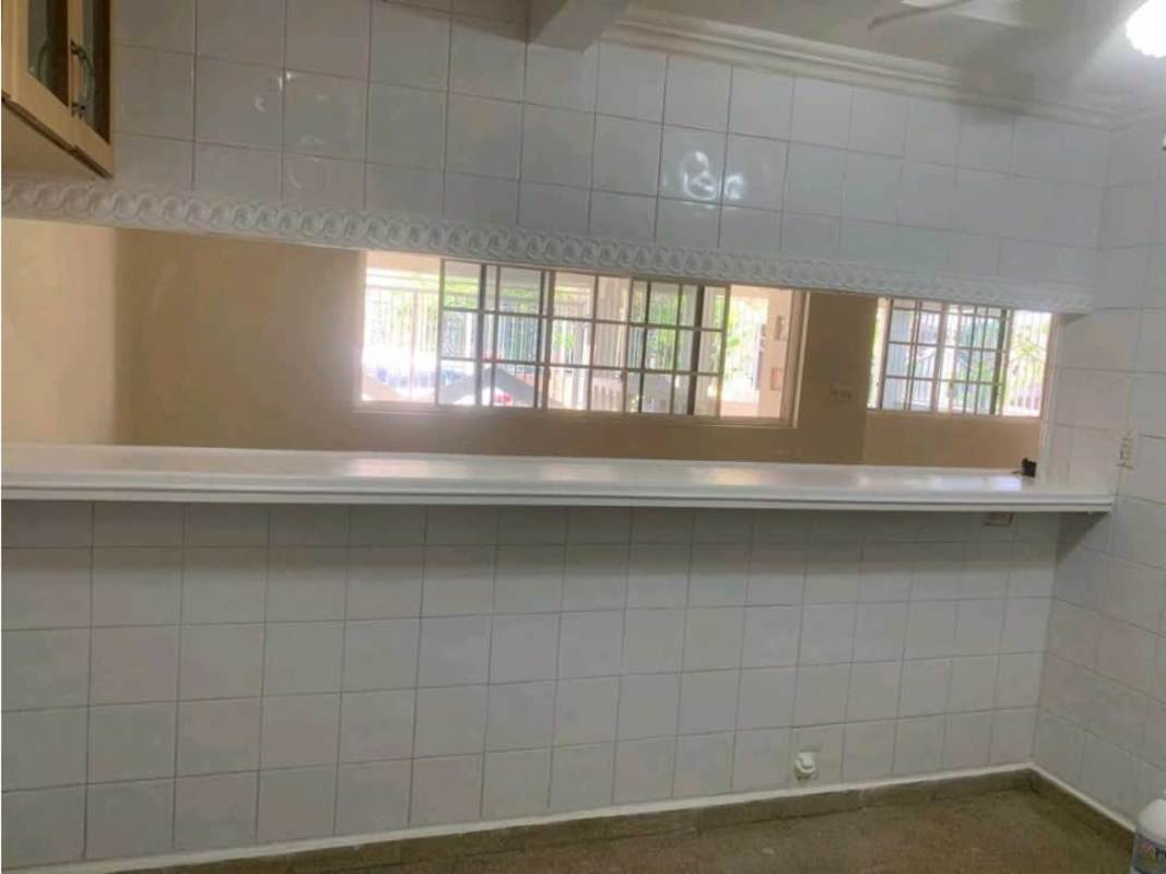 Kitchen with white tiled wall and open window towards living Villa Lucre house Panama