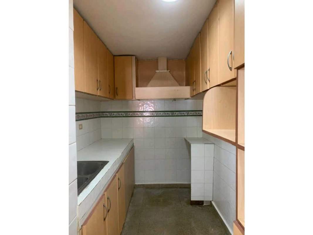 Compact galley kitchen with decorative tile trim and wood cabinets Villa Lucre Panama