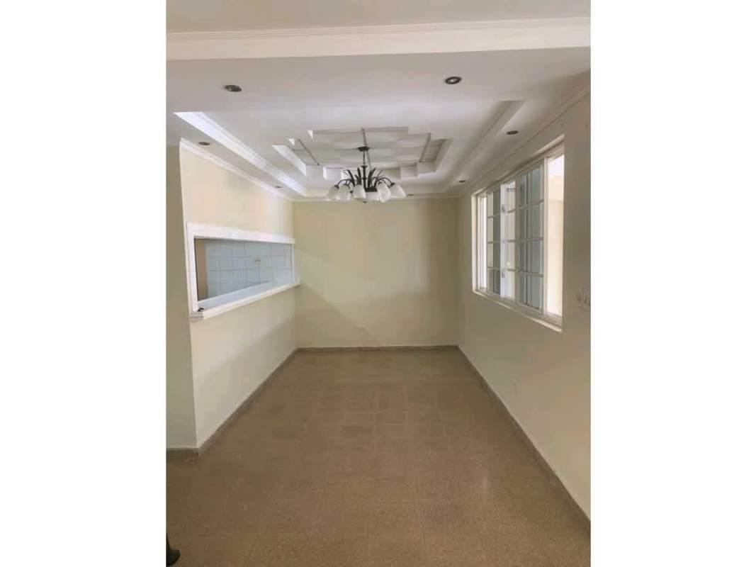 Dining room with chandelier, large windows and neutral colors in Villa Lucre property