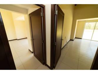 Kitchen area with modern dark cabinetry granite counters vaulted ceiling in Costa Blanca Villa Panama