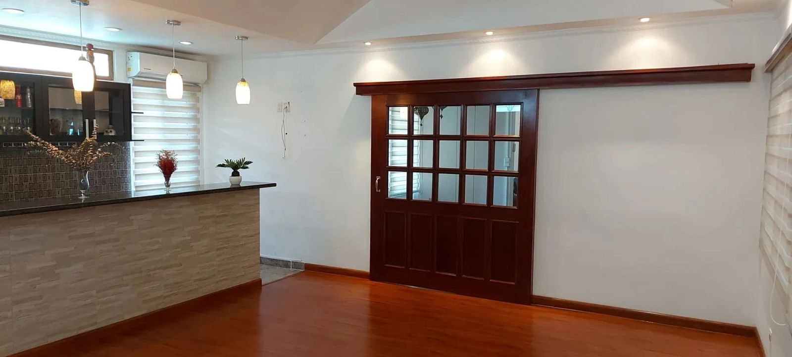 Interior dining space with built-in bar pendant lights glass doors Panama Clayton Balboa house for sale