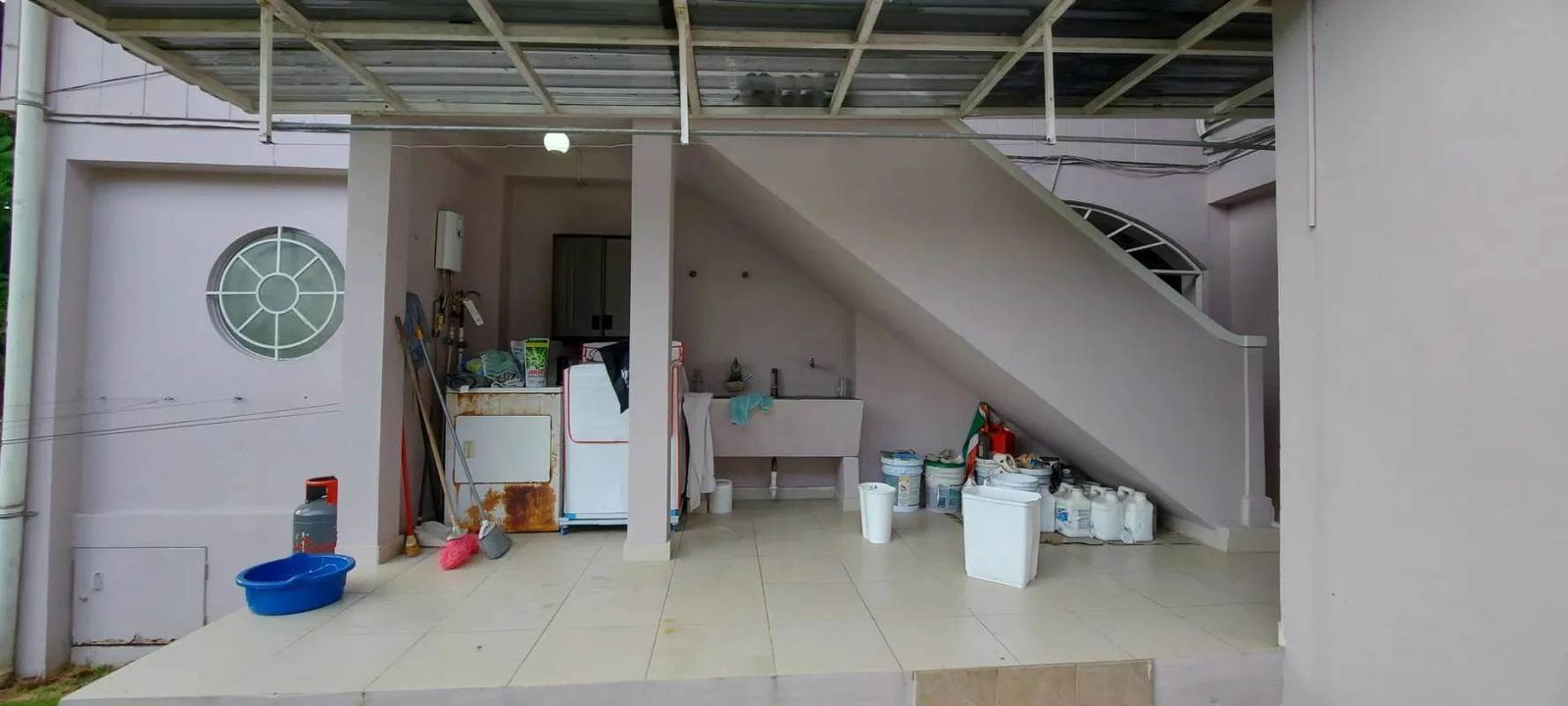 Covered laundry/utility space with storage under stairs patio area Clayton Panama house for sale