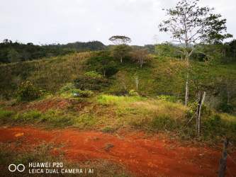Rural hills with dirt paths, green vegetation, and fenced areas in Santa Rosa Capira Panama