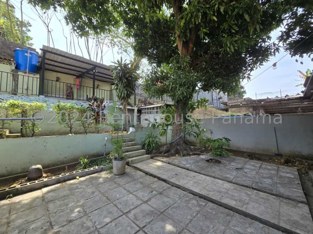 Large terrace patio with garden views, mature trees in backyard of house in Hato Pintado Panama