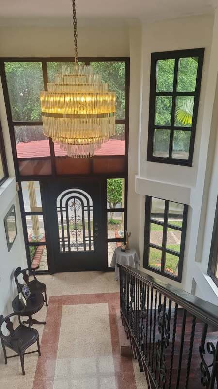 Two-story foyer with iron stair railing and chandelier in Albrook rental house