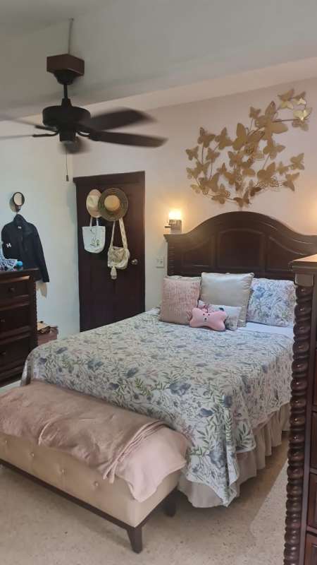 Bedroom with wooden bed set, ceiling fan, classic decor in Albrook rental home