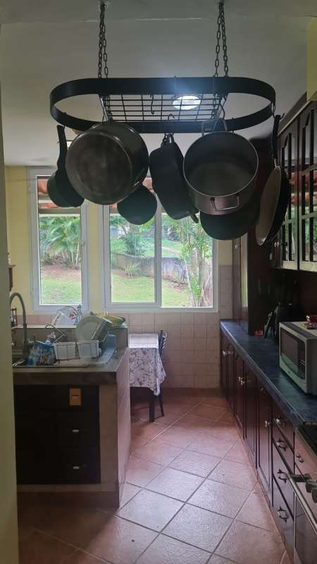 Traditional kitchen with window to garden hanging pots and granite Albrook rental