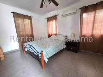 Kitchen with white cabinetry granite tops tile flooring beach home for sale Coronado Panama